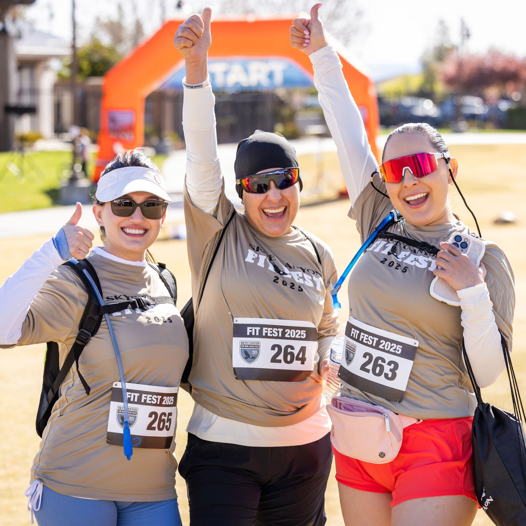 Happy women runners celebrating outdoors at a community event during FIT FEST 2025.